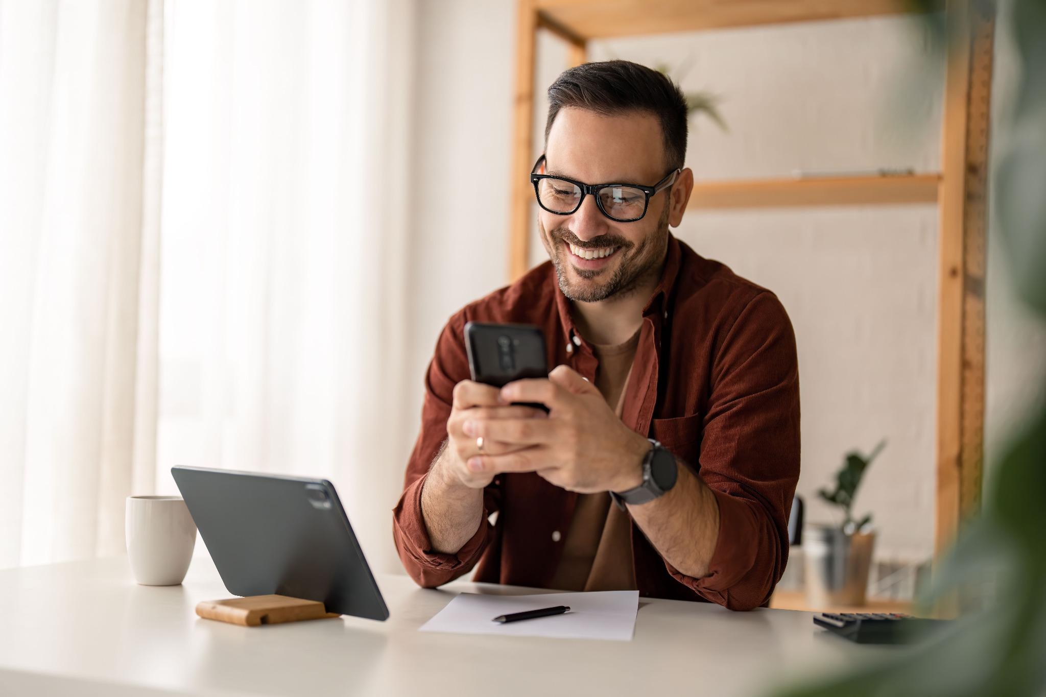 man-phone-smiling-desk