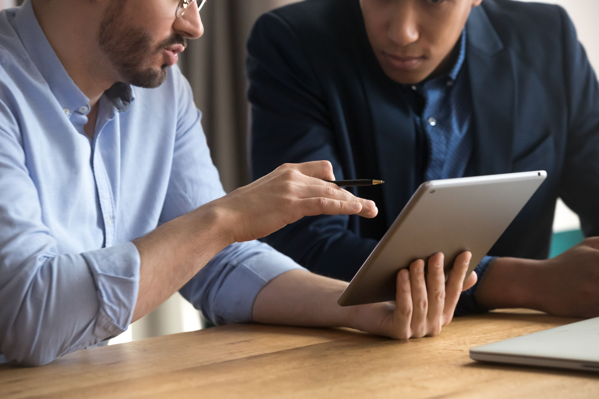 two-men-tablet-discussion